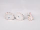 three porcelain figurines of a woman and a man