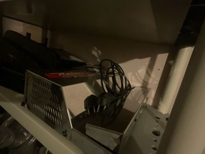 a microwave that has a bunch of items on top of it