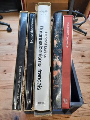three books that are sitting in a box on a table