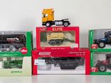 four different models of tractors in boxes on a table