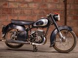 a motorcycle that is parked in front of a brick wall