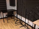 a room with a desk, chair, and sound booth