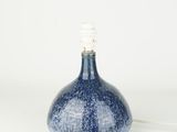 a small blue vase with a light on top of it