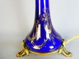 a blue vase with a gold decoration on it