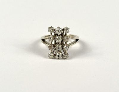 a close up of a diamond ring on a white surface