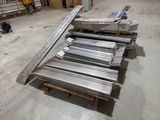 several pieces of metal are stacked on top of pallets in a warehouse