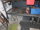 a shelf that has tools on it in a room