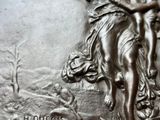 a close up of a silver coin with a woman on it