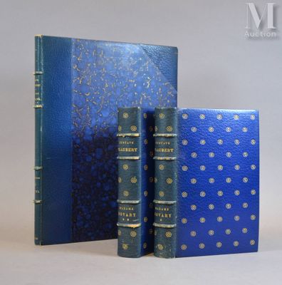 two blue books sitting next to each other on a white surface