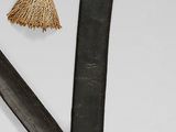 two different types of knives on a white surface