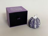 purple box with black lid and white polka dot design next to a black box with a white polka dot design on it