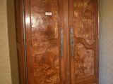 a large wooden armoire in the corner of a room