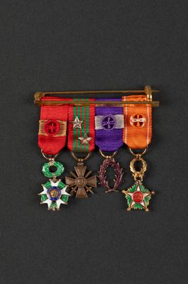 a close up of a group of medals on a black surface