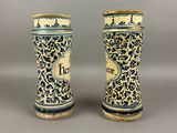 pair of blue and white vases sitting on top of a table