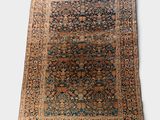 an antique persian rug with a blue and brown design