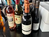 several bottles of wine are lined up on a black table