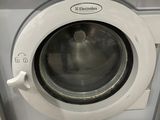 a washing machine that is sitting in a bathroom