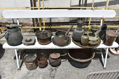 many pots and pans sitting on a white bench