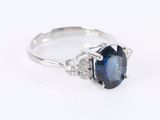 a close up view of a sapphire and diamond ring on a white background