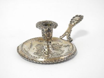an image of a silver plate with a candle holder on it