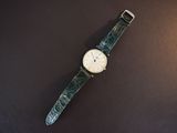 an image of a watch sitting on top of a black surface