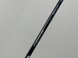 a close up of a black and white fishing rod on a gray background