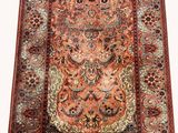 a red and blue rug with a medallion design on it