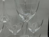 several wine glasses are stacked on top of each other on a table