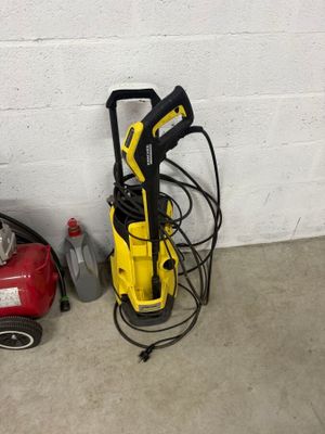 a yellow pressurer sitting next to a red and black vacuum