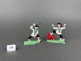 two figurines of a man with a sword and a woman with a sword