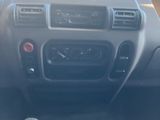 a dashboard of a car with a steering wheel and dashboard controls