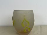 a small glass vase with a yellow design on it