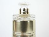 a close up of a bottle of perfume on a table