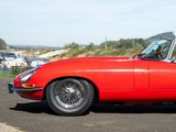 an image of a red sports car parked on the side of the road