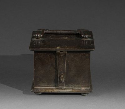 a small metal box with a handle on a gray surface