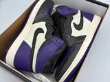 purple and black air jordan 1s in a box on a white surface