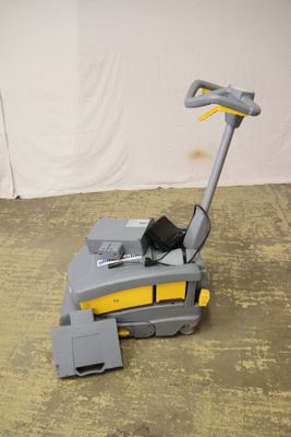 an image of a floor scruber sitting on the floor in a room