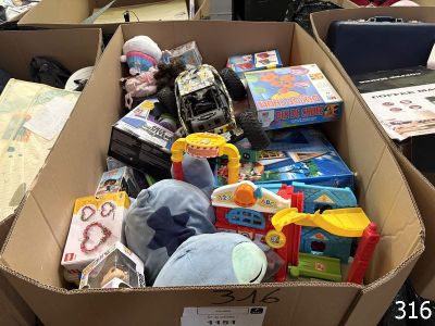 a cardboard box filled with toys and other items