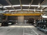 a large warehouse with a crane in the middle of it