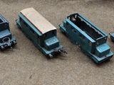 four toy trains that are sitting on the ground