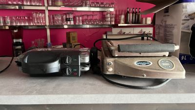 two toasters and a toaster sitting on a counter