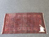 an old rug with a tag on it sitting on the floor