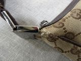 a brown and white purse with a zipper on it