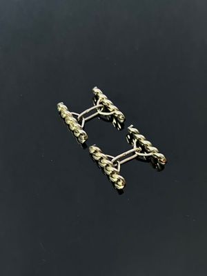 a close up of a pair of earrings on a black surface