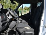 a white van with a black seat and a black bag in the back