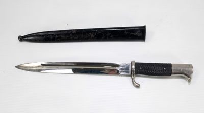 two different types of knives on a white surface