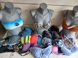 three mannequins wearing swimsuits on display in a store