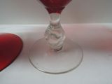 a glass of wine sitting on a table next to a mouse