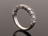 a close up of a diamond ring on a reflective surface