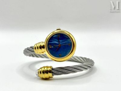 a close up of a bracelet with a blue stone on it